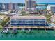 Scenic aerial view of a waterfront condo building, marina, and ocean, highlighting the prime location at 640 Bayway Blvd # 302, Clearwater Beach, FL 33767