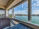 Screened in balcony with waterfront views and outdoor seating at 640 Bayway Blvd # 302, Clearwater Beach, FL 33767