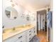Bathroom with a double sink vanity, bright lighting, and a sliding door shower at 640 Bayway Blvd # 302, Clearwater Beach, FL 33767
