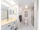 Bright bathroom featuring a white vanity with a light countertop, toilet, and a glass-enclosed shower for a clean and functional space at 640 Bayway Blvd # 302, Clearwater Beach, FL 33767
