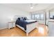 Bright bedroom with a queen bed, wood floors and a bay view from the window at 640 Bayway Blvd # 302, Clearwater Beach, FL 33767
