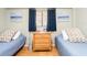 Bedroom with two twin beds, wood floors, and beach themed decor at 640 Bayway Blvd # 302, Clearwater Beach, FL 33767