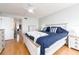 Bedroom with wood floors, a queen bed, and white walls accented by the natural light at 640 Bayway Blvd # 302, Clearwater Beach, FL 33767