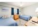 Bedroom with two twin beds, nautical themed decor, wood floors and neutral walls at 640 Bayway Blvd # 302, Clearwater Beach, FL 33767