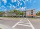 Condominium complex with multiple stories, private balconies, and mature trees along the street at 640 Bayway Blvd # 302, Clearwater Beach, FL 33767