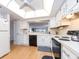 Bright kitchen features white cabinets, black appliances, and a large window providing natural light at 640 Bayway Blvd # 302, Clearwater Beach, FL 33767