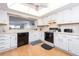 Bright kitchen featuring white cabinets, sleek black appliances, and a window to the living room at 640 Bayway Blvd # 302, Clearwater Beach, FL 33767
