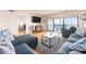 Comfortable living room featuring sofas, a TV, and access to the screened-in porch at 640 Bayway Blvd # 302, Clearwater Beach, FL 33767
