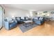 Cozy living room with sofas, chairs, and a view into the dining and kitchen areas at 640 Bayway Blvd # 302, Clearwater Beach, FL 33767