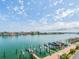 A tranquil waterfront scene featuring boat docks and a serene view of the calm bay and skyline at 640 Bayway Blvd # 302, Clearwater Beach, FL 33767