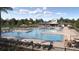 Resort-style pool with lounge chairs, umbrellas, and ample seating areas provides a luxurious outdoor experience at 6495 Propel Run, New Port Richey, FL 34655