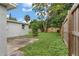 The backyard features lush landscaping, a fenced perimeter, and a concrete patio at 6612 W Chelsea St, Tampa, FL 33634
