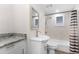 Charming bathroom featuring a vanity, commode, shower, and tub combination at 6612 W Chelsea St, Tampa, FL 33634