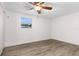 A well-lit bedroom featuring a ceiling fan and wood-look flooring at 6612 W Chelsea St, Tampa, FL 33634
