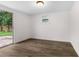 Bright bedroom with wood-look floors and a sliding glass door to the backyard at 6612 W Chelsea St, Tampa, FL 33634