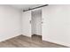 Bedroom with wood-look floors and a modern sliding closet door at 6612 W Chelsea St, Tampa, FL 33634