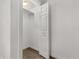 A well-lit closet with a rod and shelving, providing ample storage space, complemented by wood-look flooring at 6612 W Chelsea St, Tampa, FL 33634