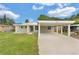 Charming single-story home with a well-maintained lawn and covered parking at 6612 W Chelsea St, Tampa, FL 33634