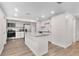 Bright kitchen featuring a kitchen island, stainless steel appliances, and white cabinetry, creating a modern cooking space at 6612 W Chelsea St, Tampa, FL 33634