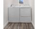 Convenient laundry area with a washer and dryer, designed for efficient laundry tasks with durable wood-look flooring at 6612 W Chelsea St, Tampa, FL 33634