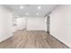 Bright living room featuring wood-look floors, recessed lights, and a modern sliding door at 6612 W Chelsea St, Tampa, FL 33634