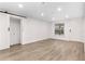 Bright living room featuring wood-look floors, recessed lights, and a closet at 6612 W Chelsea St, Tampa, FL 33634