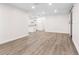 Bright living room featuring wood-look floors and recessed lights, connecting to the kitchen at 6612 W Chelsea St, Tampa, FL 33634