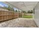 A covered patio with brick flooring and views of the backyard at 6612 W Chelsea St, Tampa, FL 33634