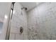 A stylish shower featuring modern tile work with a mosaic pattern, creating a spa-like atmosphere at 6612 W Chelsea St, Tampa, FL 33634