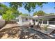 Cozy backyard features a wood deck with chairs, a fire pit, and string lights, perfect for outdoor relaxation at 7201 5Th N Ave, St Petersburg, FL 33710