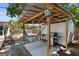 Relaxing backyard setup with a hammock, barbecue grill, and covered area, ideal for outdoor gatherings at 7201 5Th N Ave, St Petersburg, FL 33710