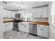 Bright kitchen featuring white cabinets, butcher block countertops, and stainless steel appliances at 7201 5Th N Ave, St Petersburg, FL 33710