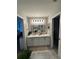Well-lit bathroom featuring double sinks, a decorative mirror, and neutral tones at 7221 Sterling Point Ct, Gibsonton, FL 33534