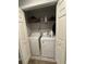 Laundry closet featuring a washer and dryer unit with shelf storage above at 7221 Sterling Point Ct, Gibsonton, FL 33534