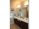 Bathroom with double sinks, vanity, large mirror and nautical decor at 8009 Trimbelle Ter, Parrish, FL 34219