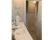 Clean bathroom featuring a white countertop vanity, decorative mirror, and a neutral color scheme at 8009 Trimbelle Ter, Parrish, FL 34219