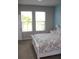 Bedroom with pond view, light gray walls and coastal themed bedding at 8009 Trimbelle Ter, Parrish, FL 34219