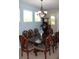 Dining room with a large wood table, ornate chairs, and decorative chandelier at 8009 Trimbelle Ter, Parrish, FL 34219