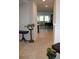 Neutral hallway leading into the living room with views of modern furniture and natural light at 8009 Trimbelle Ter, Parrish, FL 34219
