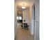 Inviting hallway with decorative wainscoting, neutral paint, and views into the living room at 8009 Trimbelle Ter, Parrish, FL 34219