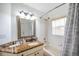 Well-lit bathroom with a marble vanity and bathtub with shower at 815 Sandy Trail Pl, Brandon, FL 33511