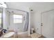 Bright bathroom featuring a shower-tub combo, single sink, and door to the exterior at 815 Sandy Trail Pl, Brandon, FL 33511