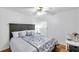 Cozy bedroom featuring a decorative comforter, ceiling fan, and hardwood floors at 815 Sandy Trail Pl, Brandon, FL 33511