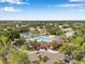 Aerial view of the community clubhouse with a pool, tennis courts and lush landscaping at 815 Sandy Trail Pl, Brandon, FL 33511