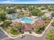 Aerial view of the community clubhouse with a pool, tennis courts and lush landscaping at 815 Sandy Trail Pl, Brandon, FL 33511