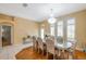 A luxurious dining room featuring hardwood floors, wainscoting, a fancy chandelier, and abundant natural light at 815 Sandy Trail Pl, Brandon, FL 33511