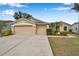 Inviting home with a well-maintained yard, two-car garage, and vibrant landscaping at 815 Sandy Trail Pl, Brandon, FL 33511