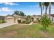 Attractive home with a two-car garage, well-kept lawn, and lush landscaping at 815 Sandy Trail Pl, Brandon, FL 33511