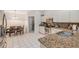 Well-lit kitchen with granite countertops, stainless steel appliances, and white tile flooring at 815 Sandy Trail Pl, Brandon, FL 33511