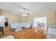 Spacious living room with modern ceiling fan and sliding glass doors to the patio at 815 Sandy Trail Pl, Brandon, FL 33511